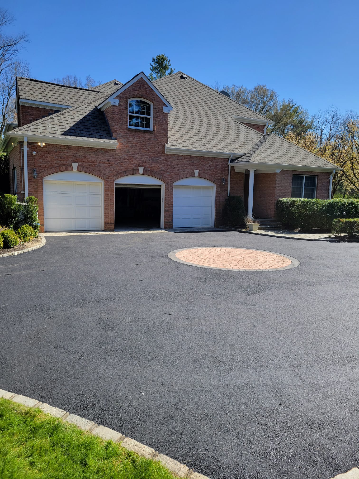 Freshly paved residential asphalt driveway by A-Top Paving, DBA Florida Paving Pros in Palm Beach County, featuring precise edges and professional finish.