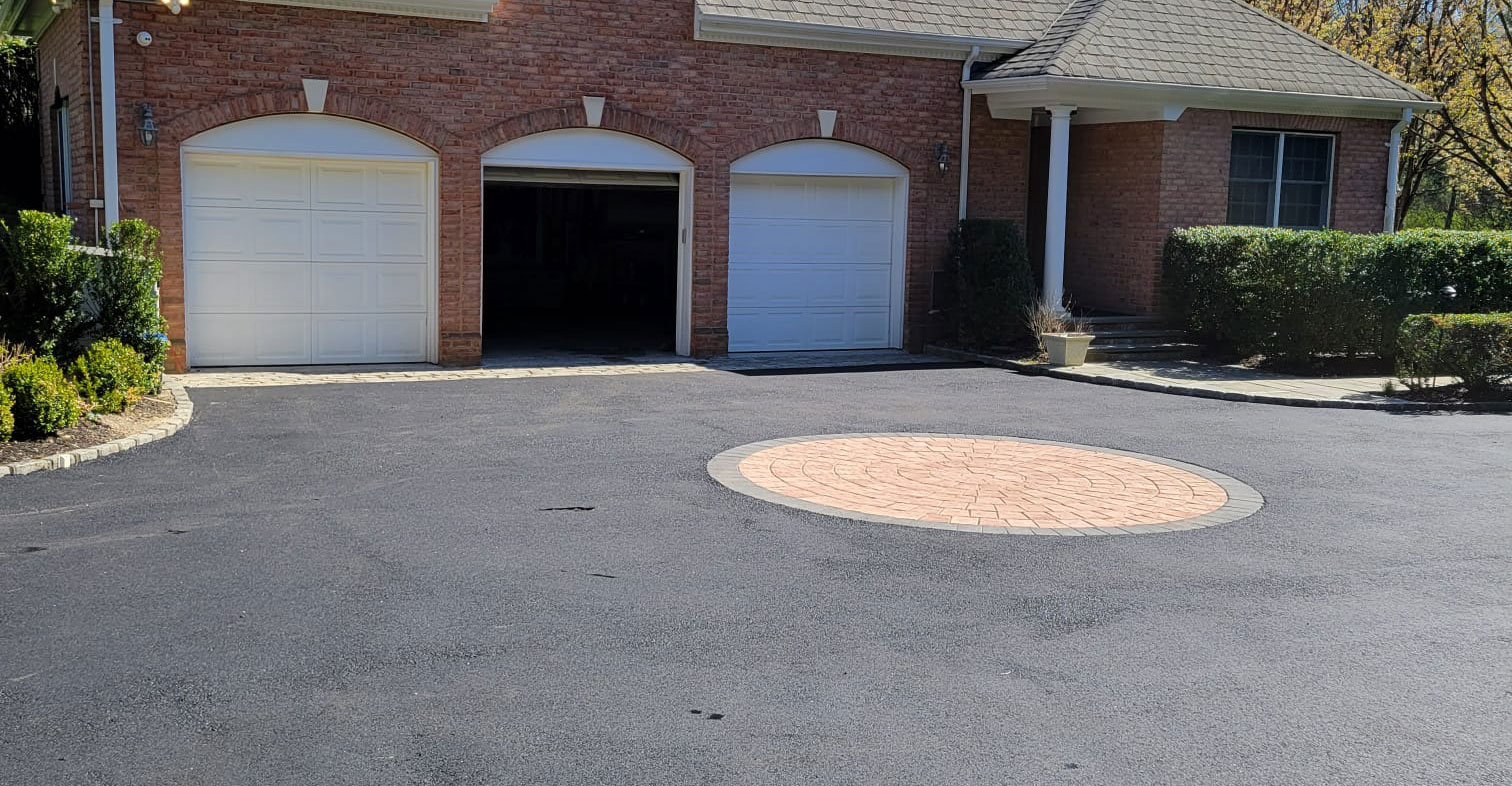 Welcoming asphalt driveway leading to a residential property, where A-Top Paving, DBA Florida Paving Pros provides expert paving services and welcomes  inquiries from residential and commercial clients alike in Palm Beach County.